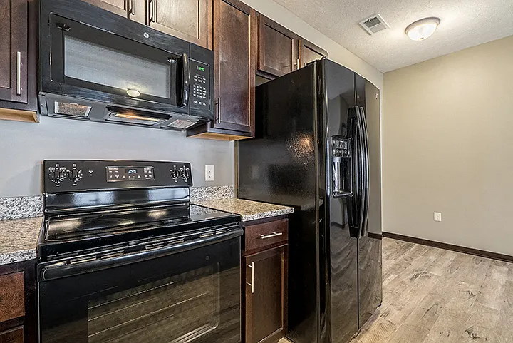 Our homes feature sleek black appliances in each kitchen.