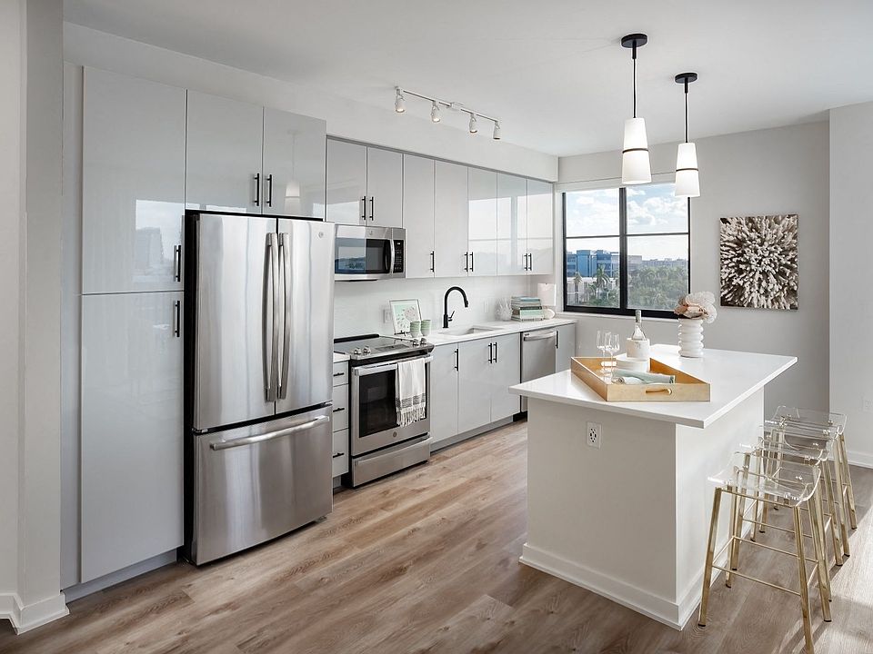 Stunning kitchens include contemporary European-style cabinets and designer pendant lighting.