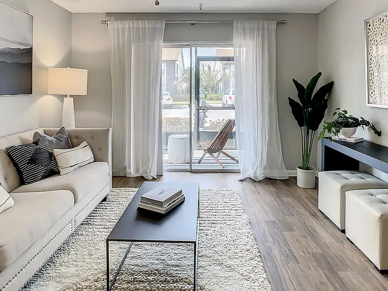Unwind in our spacious living rooms with ceiling fans and private patio access.