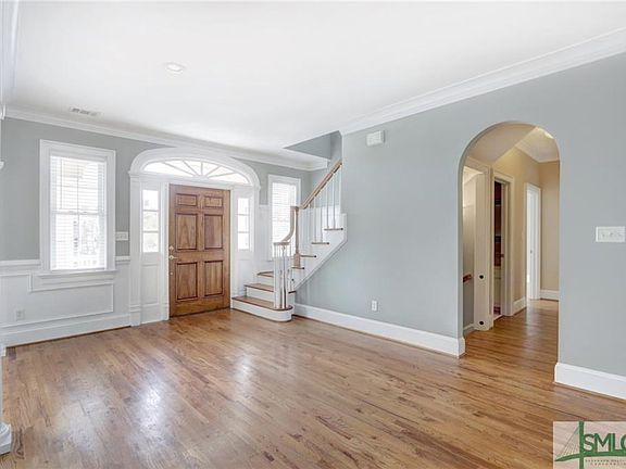 Gracious foyer greets your guests with natural light and gorgeous hardwood floors