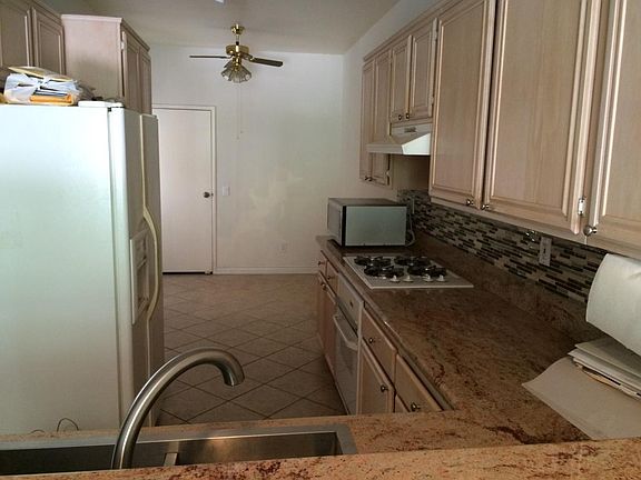 kitchen with granite counter tops and desk/dining table spac