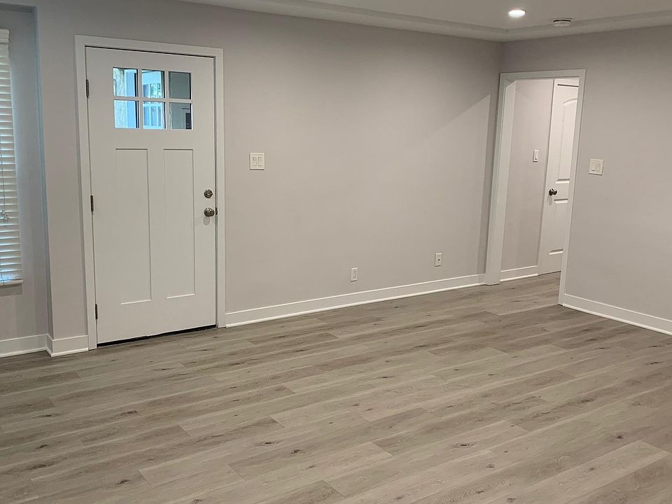 View of living room and front door, as seen from the dining area.