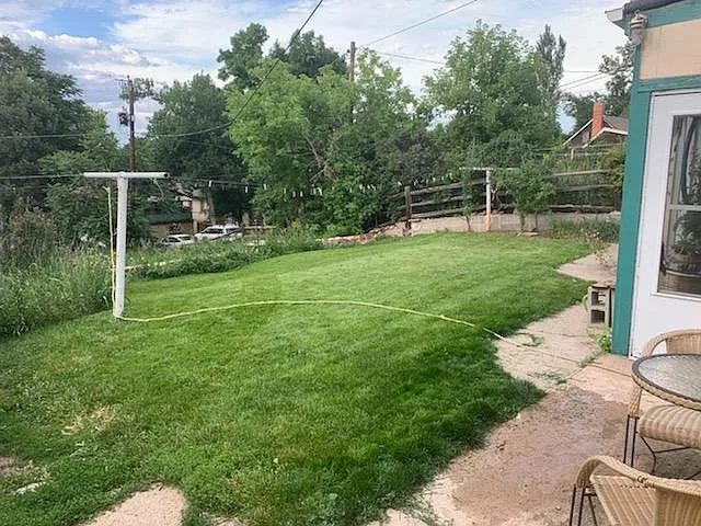 Back yard with organic dryer. Garden is one level down (past the line of taller plants).