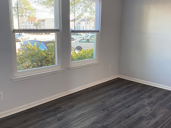 View from hallway into dining room with 3 large windows