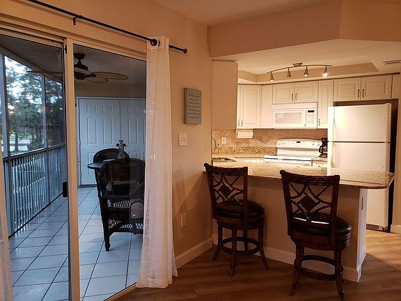 Kitchen and exit to private lanai over looking the Gulf Course