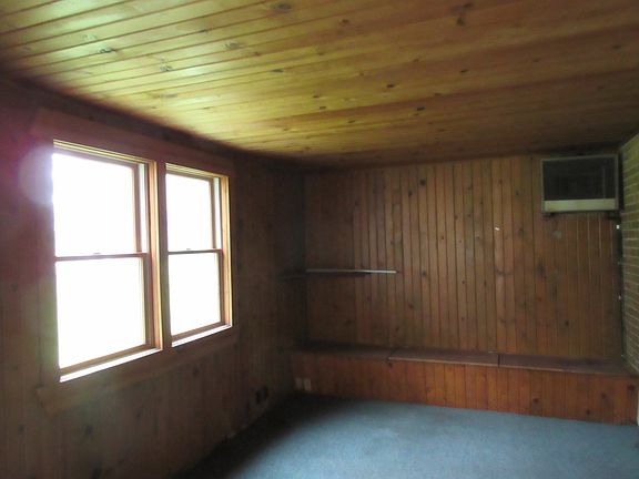 This enclosed porch could also be a family room--great view of the  large back yard!