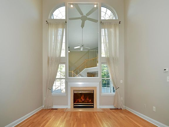 high ceiling living room with gas fireplace