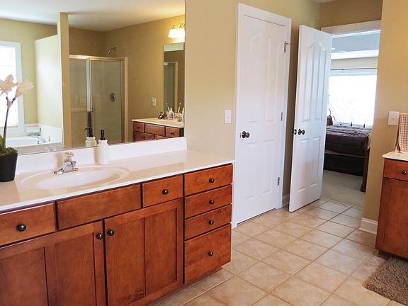 The master bath has separate vanities and two walk-in closets.