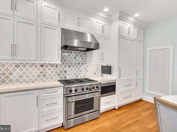Recently updated kitchen with built in sub zero refrigerator, large 6-burner range and lots of storage space