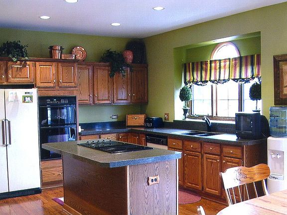 Large kitchen with island and granite counter tops.