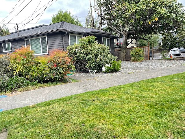 Looking northwest at the triplex from Minor Ave E.