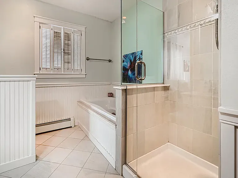 Upper master bathroom with large deep bathtub and large shower. Newly updated.