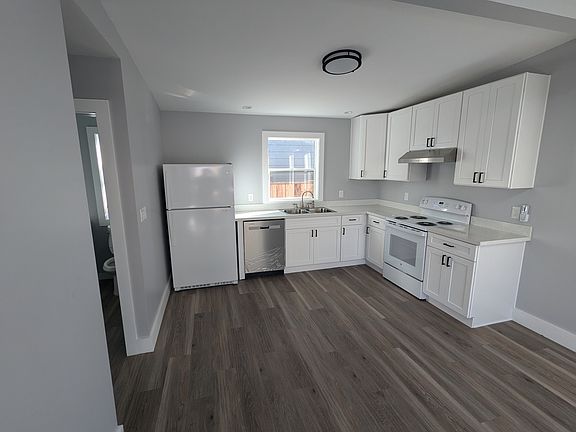 Brand new kitchen with new stove, sink, refrigerator, and dishwasher.