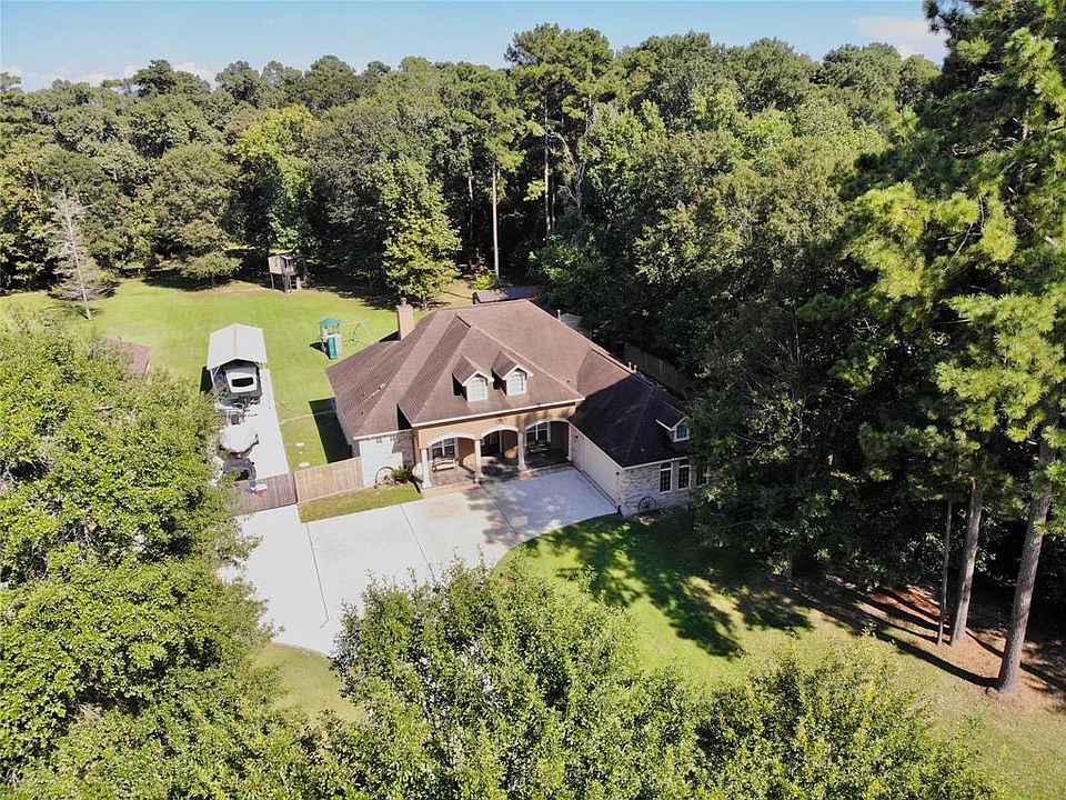 Stunning One Story, 3/4 Bedroom Home is located on 1.6 acres, surrounded by majestic trees for a scenic setting ~ Large,Covered Patio Enjoys the Beautiful Views ~ Covered RV Parking with additional parking for your boat & trailer.