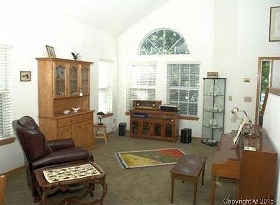 The living and dining rooms are connected with vaulted ceilings.