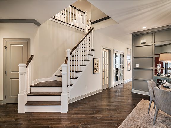 Foyer Opens To An Elegant Staircase And Formal Dining Room