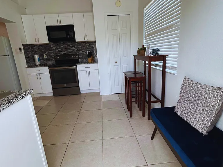 Studio with window, beautiful blinds, and excellent natural lighting.