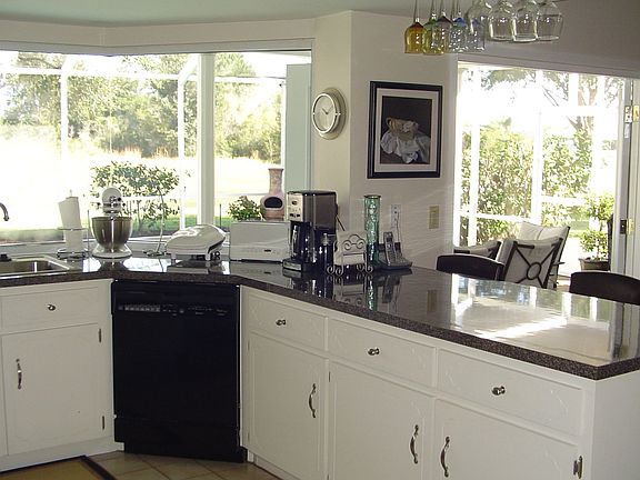 Bay window in kitchen with sparkling views of pool, canal 