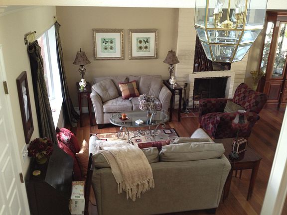 Living room with wood-burning fireplace; gas starter.