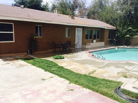 Front of house with pool view
