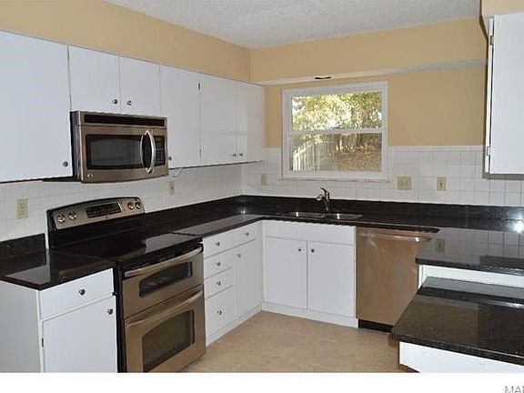 Stainless steel appliance include double oven, microwave and dishwasher. Ceramic tile flooring and granite countertops.