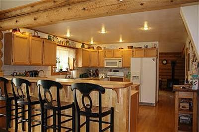 The large kitchen is open to the family room, with the practical breakfast bar between.
