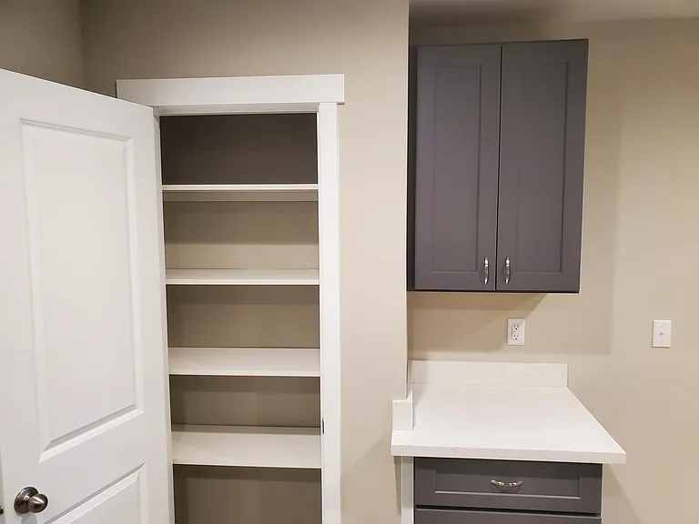 Kitchen pantry and additional cabinets/drawers.