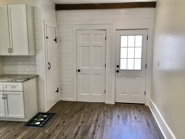 From left to right: door to basement, door to main bathroom and laundry, door to private deck