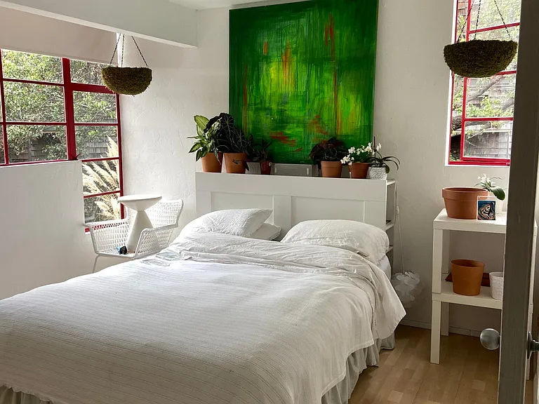 First bedroom, featuring natural light and glass window design. Not photographed is wall-width accordian, all-white, style closet.