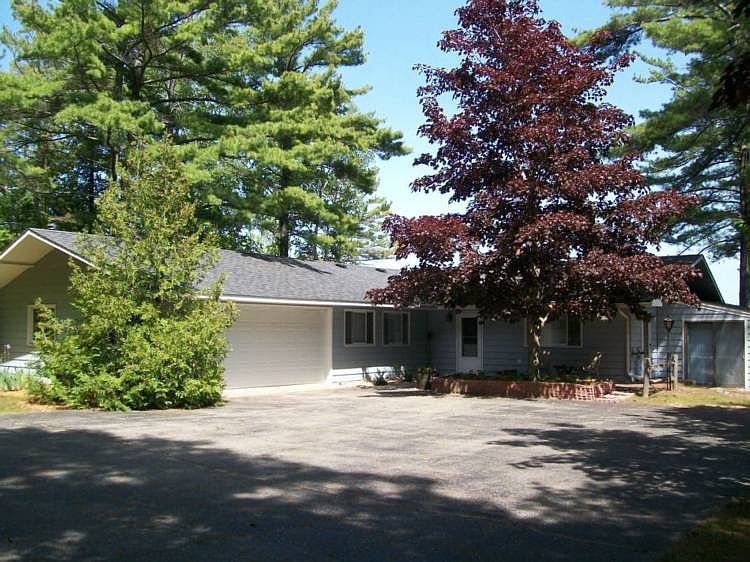 LOVELY 3 BEDROOM, 2 BATH HOME ON LAKE HURON.  HAS 100' OF BEAUTIFUL, SANDY WALKING BEACH.  HOME SITS ON 478' DEEP, WOODED LOT.  COMES COMPLETE WITH ALL KITCHEN APPLIANCES AND WASHER & DRYER.  WINDOWS ALL THE WAY ACROSS THE FRONT FACING THE LAKE.  IT HAS A DOUBLE SIDED, WOOD BURNING FIREPLACE BETWEEN THE DINING ROOM AND LIVING ROOM.  ALL THREE BEDROOMS ARE MASSIVE.  THERE IS ALSO A 4-SEASON SUNROOM.  LOTS OF STORAGE, BUILT-INS AND AN ATTACHED, HEATED, 2-CAR GARAGE.  IT ALSO HAS AN 8 x 12 SHED AND A 10 x 14 SHED.