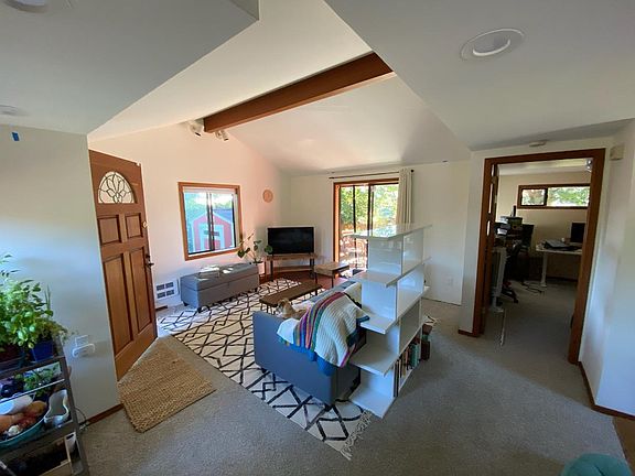 Living room has high ceilings and lots of natural light.