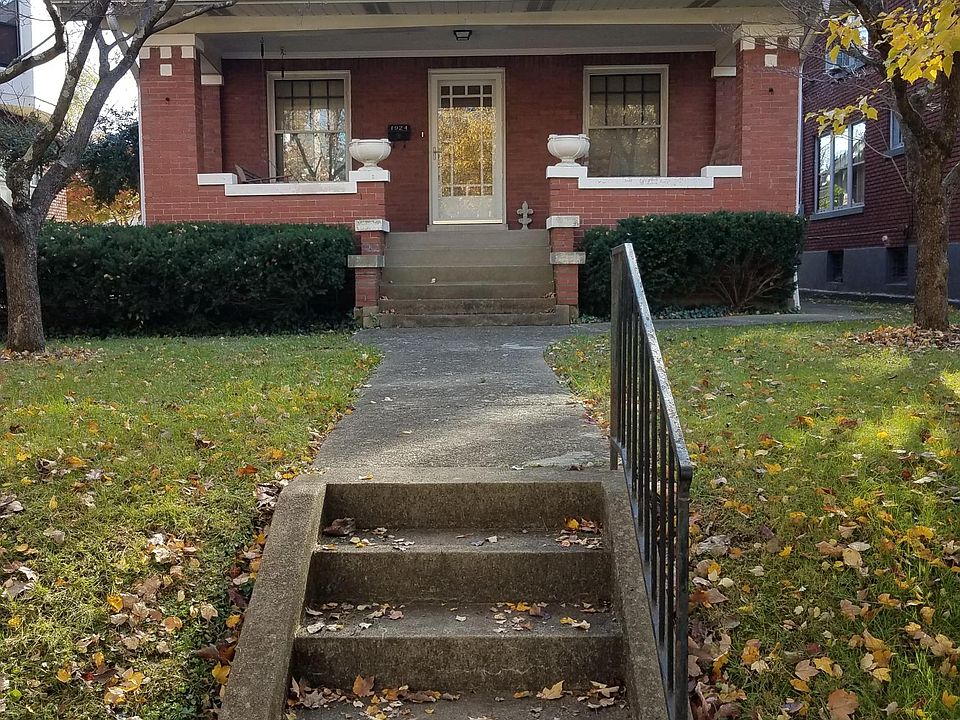 This is the front of the house showing the large porch with sitting swing.