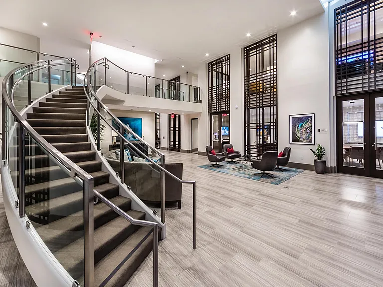 Spacious lobby with sweeping staircase and inviting seating areas.