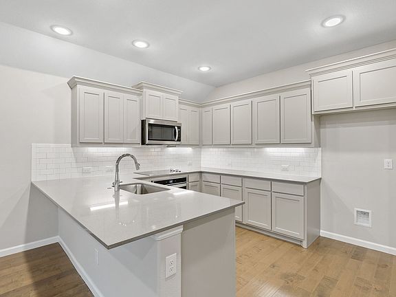 Kitchen in the Pulitzer home plan by Trophy Signature Homes - REPRESENTATIVE PHOTO