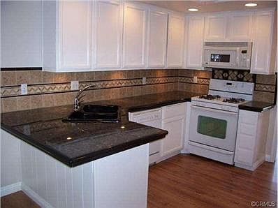 WOW! Granite tiled counter tops; decorative back splash; newer a