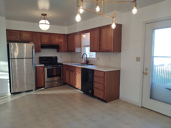 KITCHEN OPEN TO DINING AREA AND LARGE REAR DECK