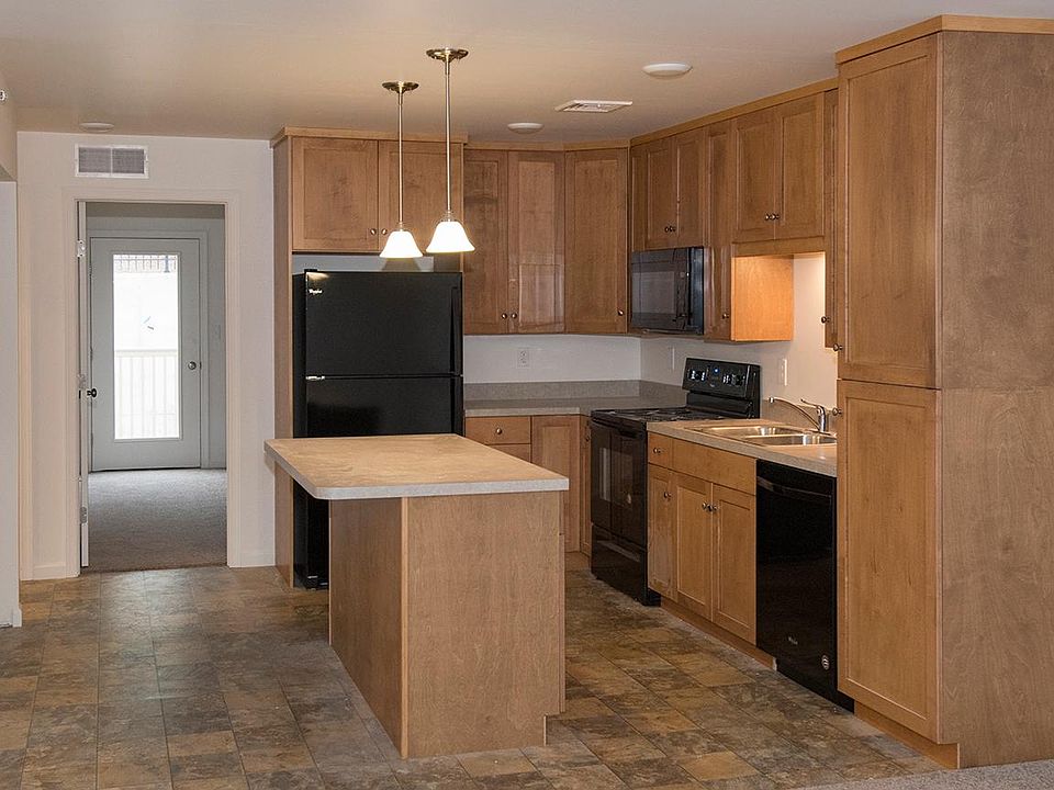 Kitchen with custom cabinetry and center island with storage (Please note: Photos are of similar unit.)