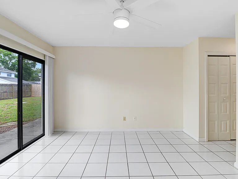 Primary bedroom with double closets and sliders to back yard