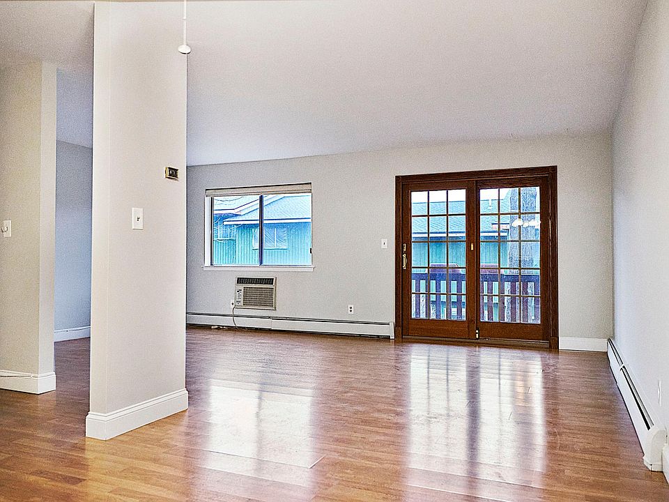 Spacious living room with seasonal view of the lake, and a quiet deck for your outside enjoyment!