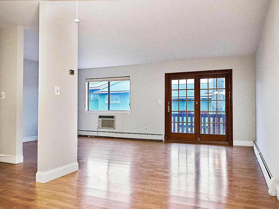 Spacious living room with seasonal view of the lake, and a quiet deck for your outside enjoyment!