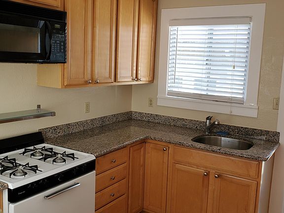 Kitchen (gas range, microwave hood fan, granite counter-tops, stainless steel under-mount sink)