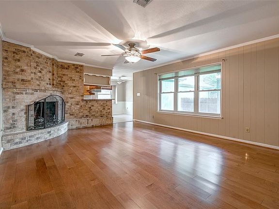 19x15 Family Room - A nice view of the family room with fireplace, windows, kitchen and breakfast room in the background.