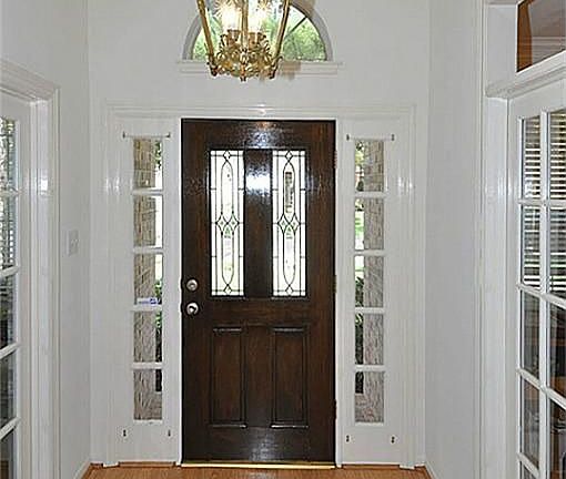 WOOD LAMINATE FLOORING, ANTIQUE FRENCH LIGHT FIXTURE, DOUBLE FRENCH DOORS LEADING INTO 4TH BEDROOM/STUDY AND FORMAL DINING