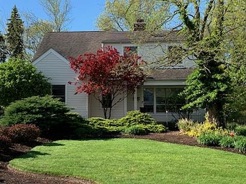 Front of the house with the beautiful landscape.