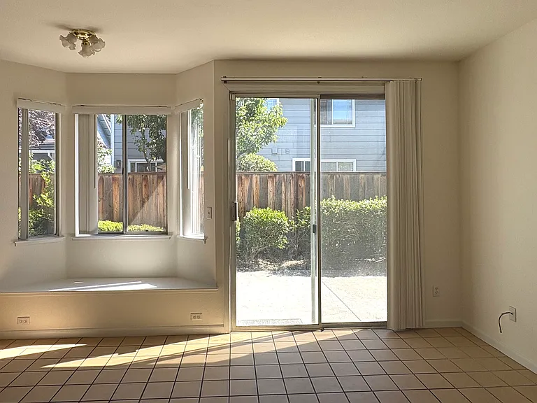 Spacious Family Room featuring a Cozy Fireplace & Direct Backyard Access