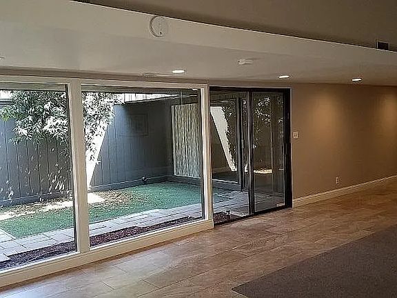 Beautiful lighten floorplan with marble tile and custom rugs.