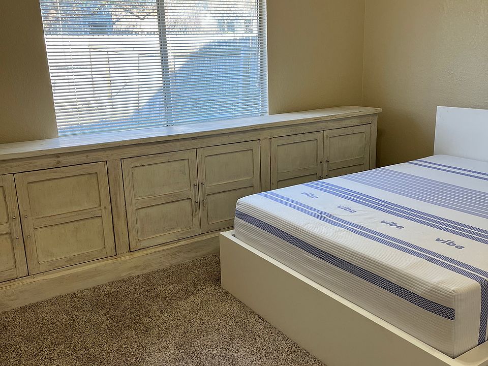 Main bedroom, as shown with Queen bed. The storage along the window is permanent