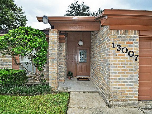 Covered porch to greet guests and fine landscaping!