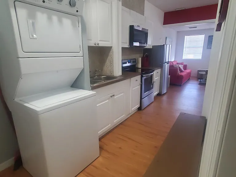 Laundry area has a bench and a washing machine
