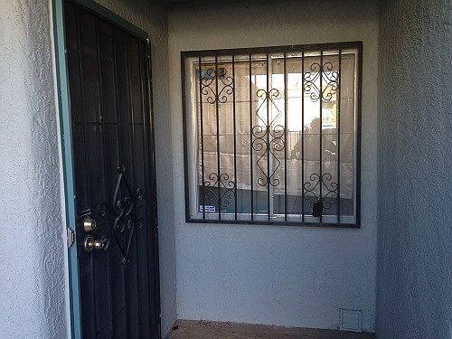 Front of condo has metal security door and window protection